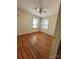 Bright bedroom featuring hardwood floors and natural light from two windows at 5364 Millersville Rd, Taylorsville, NC 28681