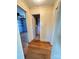 Hallway leading to bedroom and bathroom, featuring hardwood floors and neutral-toned walls at 5364 Millersville Rd, Taylorsville, NC 28681