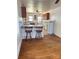 Cozy kitchen with breakfast bar, cabinets, and wood flooring at 5364 Millersville Rd, Taylorsville, NC 28681