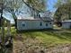 Side view of cozy cottage with a metal roof, and a storage shed is visible at 5364 Millersville Rd, Taylorsville, NC 28681