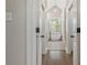 Hallway view of a luxurious bathroom featuring a soaking tub, tiled floors and modern fixtures at 5538 Camelot Dr, Charlotte, NC 28270