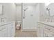 Bathroom featuring double sinks and a white tiled shower at 5538 Camelot Dr, Charlotte, NC 28270