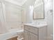 Standard bathroom featuring a tub/shower combination, toilet and vanity with neutral colors and a framed mirror at 5538 Camelot Dr, Charlotte, NC 28270