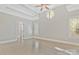 Spacious bedroom with light hardwood floors, plantation shutters and a trey ceiling with fan at 5538 Camelot Dr, Charlotte, NC 28270
