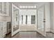 Bonus room features glass doors to an outdoor porch area with bright light and an adjacent white cabinet and beverage fridge at 5538 Camelot Dr, Charlotte, NC 28270