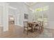Dining room with hardwood flooring, large windows with shutters, chandelier, and a table set for dinner at 5538 Camelot Dr, Charlotte, NC 28270
