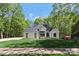 Beautifully landscaped modern home with white painted brick, a black roof, and black trim at 5538 Camelot Dr, Charlotte, NC 28270