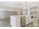 Spacious kitchen featuring a large island with quartz countertops, stainless appliances and modern lighting at 5538 Camelot Dr, Charlotte, NC 28270