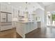 Spacious kitchen featuring a large island with quartz countertops, stainless appliances and modern lighting at 5538 Camelot Dr, Charlotte, NC 28270