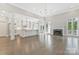 Open-concept living room with fireplace, hardwood floors, and open access to kitchen at 5538 Camelot Dr, Charlotte, NC 28270