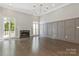 Bright living room featuring a fireplace, dark hardwood floors, high ceilings and wainscoting at 5538 Camelot Dr, Charlotte, NC 28270