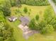 Bird's-eye view revealing this property's layout with a house, garage, expansive driveway, and greenery at 5840 Shirley Rd, Fort Lawn, SC 29714
