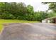 Expansive driveway leading to a detached garage, surrounded by lush greenery at 5840 Shirley Rd, Fort Lawn, SC 29714