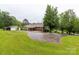 Well-maintained home exterior with large driveway, green lawn, and detached garage at 5840 Shirley Rd, Fort Lawn, SC 29714