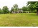 Expansive lawn leading up to a well-maintained home with a full porch and mature trees at 5840 Shirley Rd, Fort Lawn, SC 29714