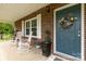 Inviting front porch with rocking chairs, brick exterior, and a decorative wreath on the front door at 5840 Shirley Rd, Fort Lawn, SC 29714