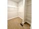 Walk-in closet featuring multiple wire shelves and carpeted floor at 627 N Alexander St, Charlotte, NC 28202
