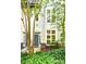 Exterior front entrance with gray door, address number, and landscaped greenery at 627 N Alexander St, Charlotte, NC 28202