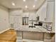 Modern kitchen features stainless steel appliances, granite countertops and white cabinetry at 627 N Alexander St, Charlotte, NC 28202