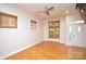 Bright living room features hardwood floors, a ceiling fan, and lots of natural light at 627 N Alexander St, Charlotte, NC 28202