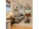 Cozy living room with sofa, rug, accent tables and view of the kitchen at 627 N Alexander St, Charlotte, NC 28202