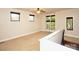Bright loft space with multiple windows, neutral carpeting, and staircase access at 627 N Alexander St, Charlotte, NC 28202