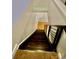 Staircase with carpeted steps and modern railings, leading towards a bright entryway at 627 N Alexander St, Charlotte, NC 28202