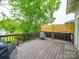 Lovely back deck with chair and wood and metal railing provides a cozy outdoor space at 705 N Fulton St, Salisbury, NC 28144