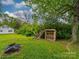 Landscaped backyard with wood storage rack, perfect for outdoor enjoyment and storage at 705 N Fulton St, Salisbury, NC 28144