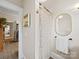 Hallway leading to a bathroom with a shower and vanity with framed mirror at 705 N Fulton St, Salisbury, NC 28144