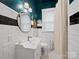 Modern bathroom showcasing a pedestal sink, stylish mirror, and a walk-in shower at 705 N Fulton St, Salisbury, NC 28144