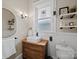 Bathroom featuring a white vessel sink on wooden vanity and decorative shelves above the toilet at 705 N Fulton St, Salisbury, NC 28144