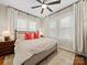 Bright bedroom featuring a large bed, hardwood floors, a ceiling fan, and two windows at 705 N Fulton St, Salisbury, NC 28144