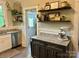 Convenient butler's pantry with granite counters, floating wood shelves, and a view of the exterior door and backyard at 705 N Fulton St, Salisbury, NC 28144