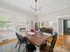 Elegant dining room boasting hardwood floors, dining table, chandelier and vintage sideboard at 705 N Fulton St, Salisbury, NC 28144