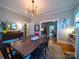 Spacious dining room with hardwood floors, dining table, chandelier, and vintage buffet cabinet at 705 N Fulton St, Salisbury, NC 28144