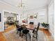 Cozy dining room open to the living room, with a fireplace, dining table and hardwood floors at 705 N Fulton St, Salisbury, NC 28144