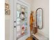 Entryway showcases a stained glass door, wicker bench, coat rack and decorative mirror for a charming welcome at 705 N Fulton St, Salisbury, NC 28144
