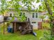 Back of home features decks, garage, and lawn in a well maintained backyard at 705 N Fulton St, Salisbury, NC 28144