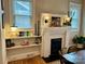 Charming fireplace with built-in shelves, decorative lamps, and plants, creating a warm atmosphere at 705 N Fulton St, Salisbury, NC 28144