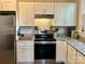 Updated kitchen features granite countertops, white cabinets, and modern stainless steel appliances, ready for cooking at 705 N Fulton St, Salisbury, NC 28144