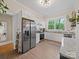 Stylish kitchen with white cabinets, stainless appliances, and a view of the greenery from the window at 705 N Fulton St, Salisbury, NC 28144