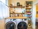 Spacious laundry room includes a folding table, storage shelves, and modern front-load washing machines at 705 N Fulton St, Salisbury, NC 28144