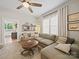 Comfortable living room showcasing a spacious sectional sofa, wood-look ceiling fan, and shelving display at 705 N Fulton St, Salisbury, NC 28144
