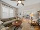 Cozy living room featuring a large sectional sofa, round coffee table, and open view to the dining area at 705 N Fulton St, Salisbury, NC 28144