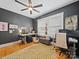 A home office featuring hardwood floors, a ceiling fan, and two windows with blinds at 705 N Fulton St, Salisbury, NC 28144
