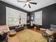 Home office featuring hardwood floors, a ceiling fan, and two windows with blinds at 705 N Fulton St, Salisbury, NC 28144
