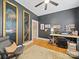 Dark-walled home office with hardwood floors, ceiling fan, and large framed artwork at 705 N Fulton St, Salisbury, NC 28144