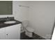 Bathroom with a granite countertop vanity and a toilet, offering essential amenities at 719 N Kelly St, Statesville, NC 28677