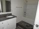 Modern bathroom featuring a granite countertop vanity and a shower-tub combination at 719 N Kelly St, Statesville, NC 28677
